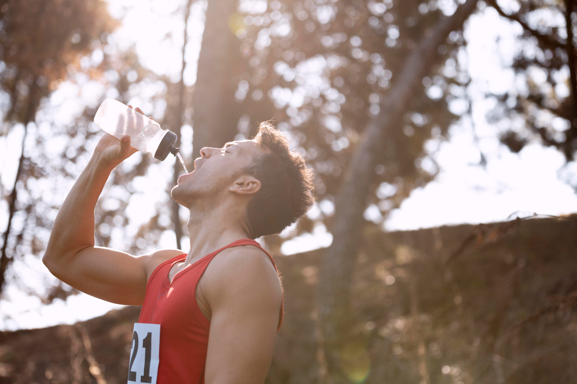 man-taking-break-from-running-drink-water