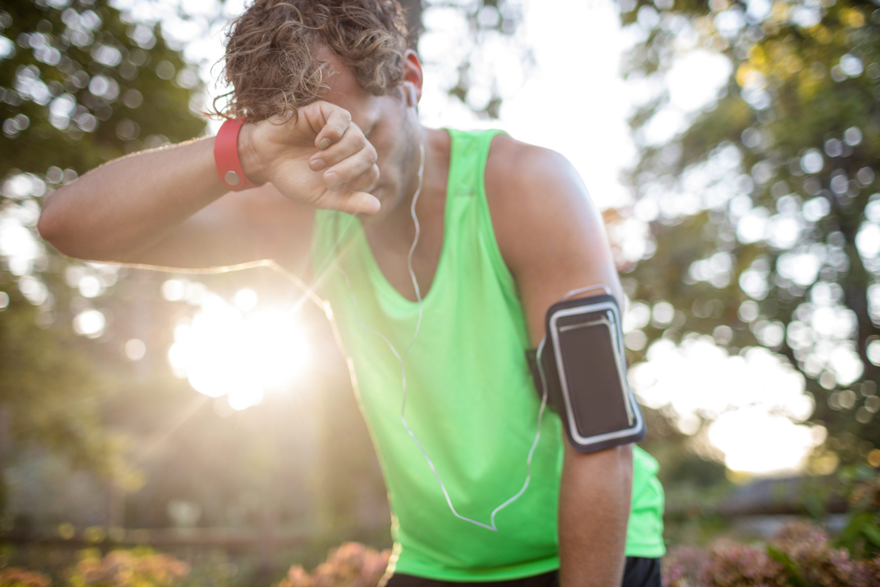 tired-man-taking-deep-breath-while-jogging