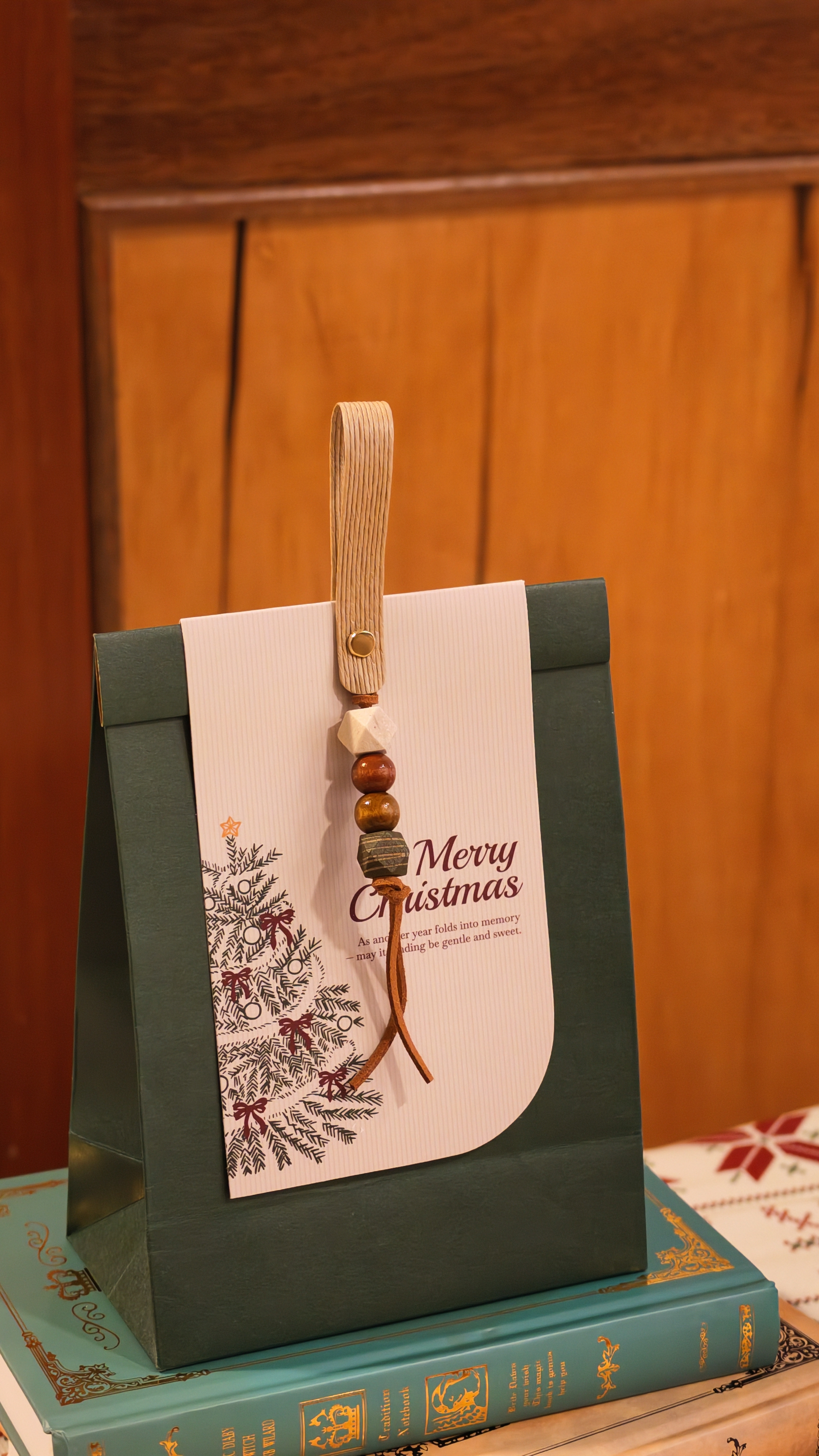 Doumo Christmas gift set resting on vintage books against warm wooden furniture