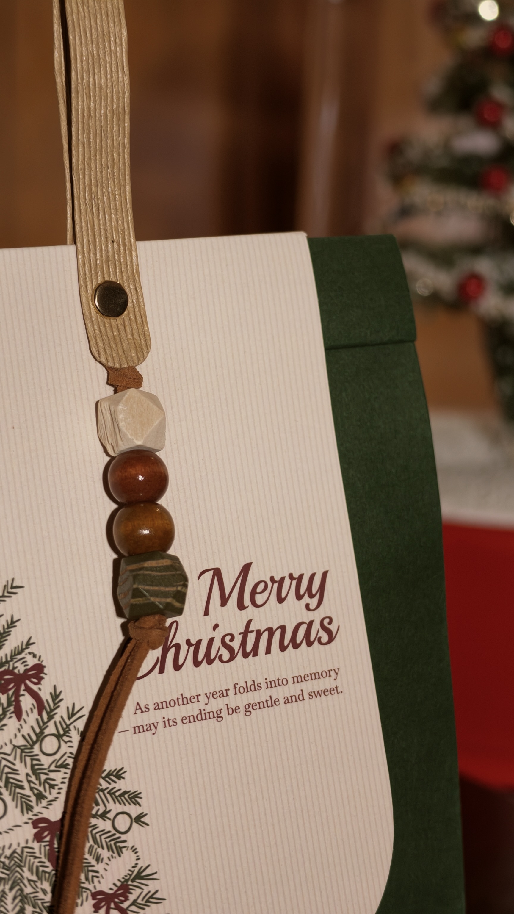 Wooden beads and Christmas tree illustration on the gift packaging
