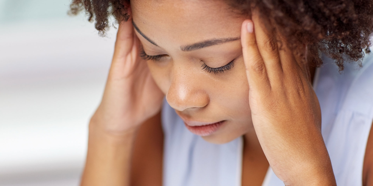 close up of african young woman touching her head