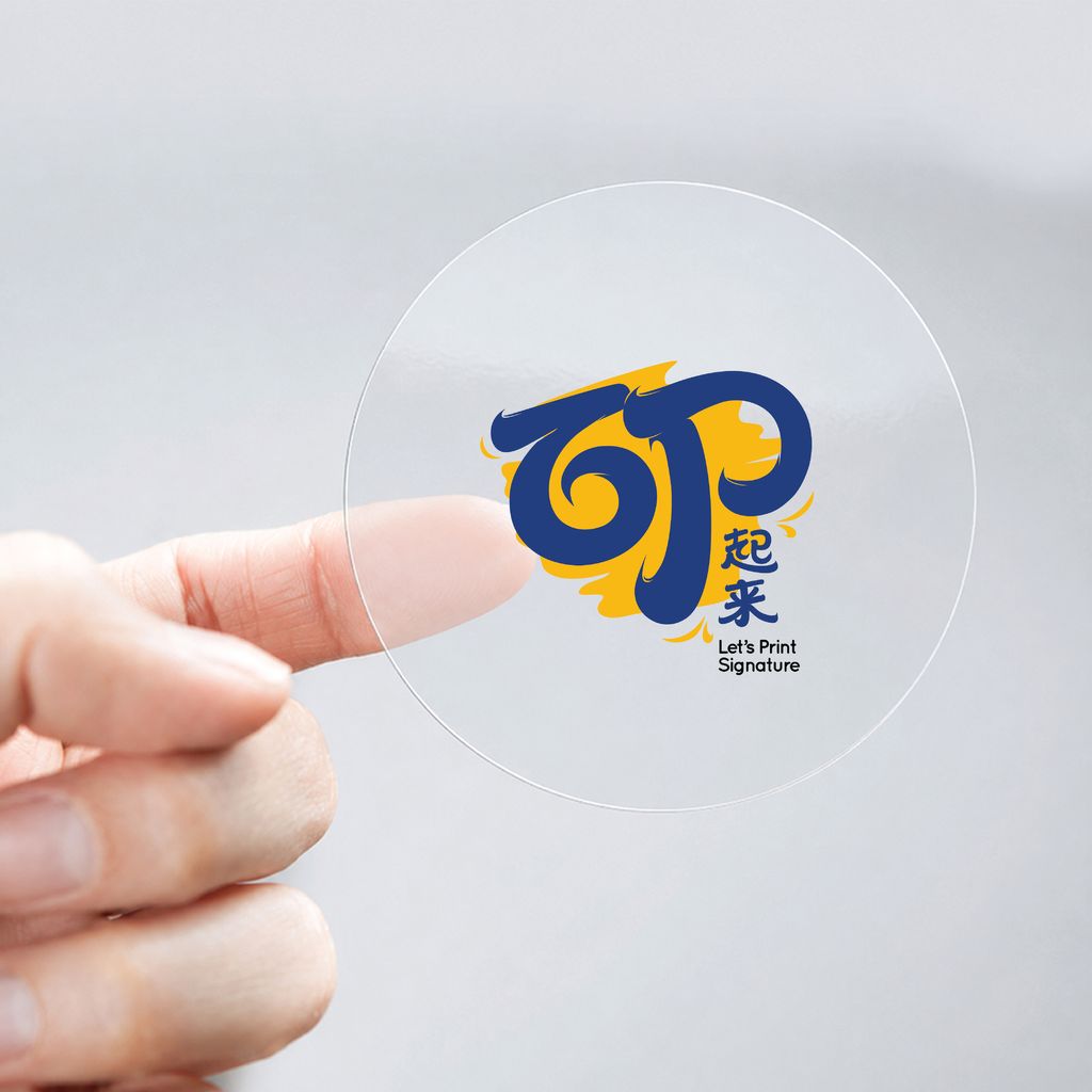 Round transparent sticker printed with a full-colour logo held between fingers