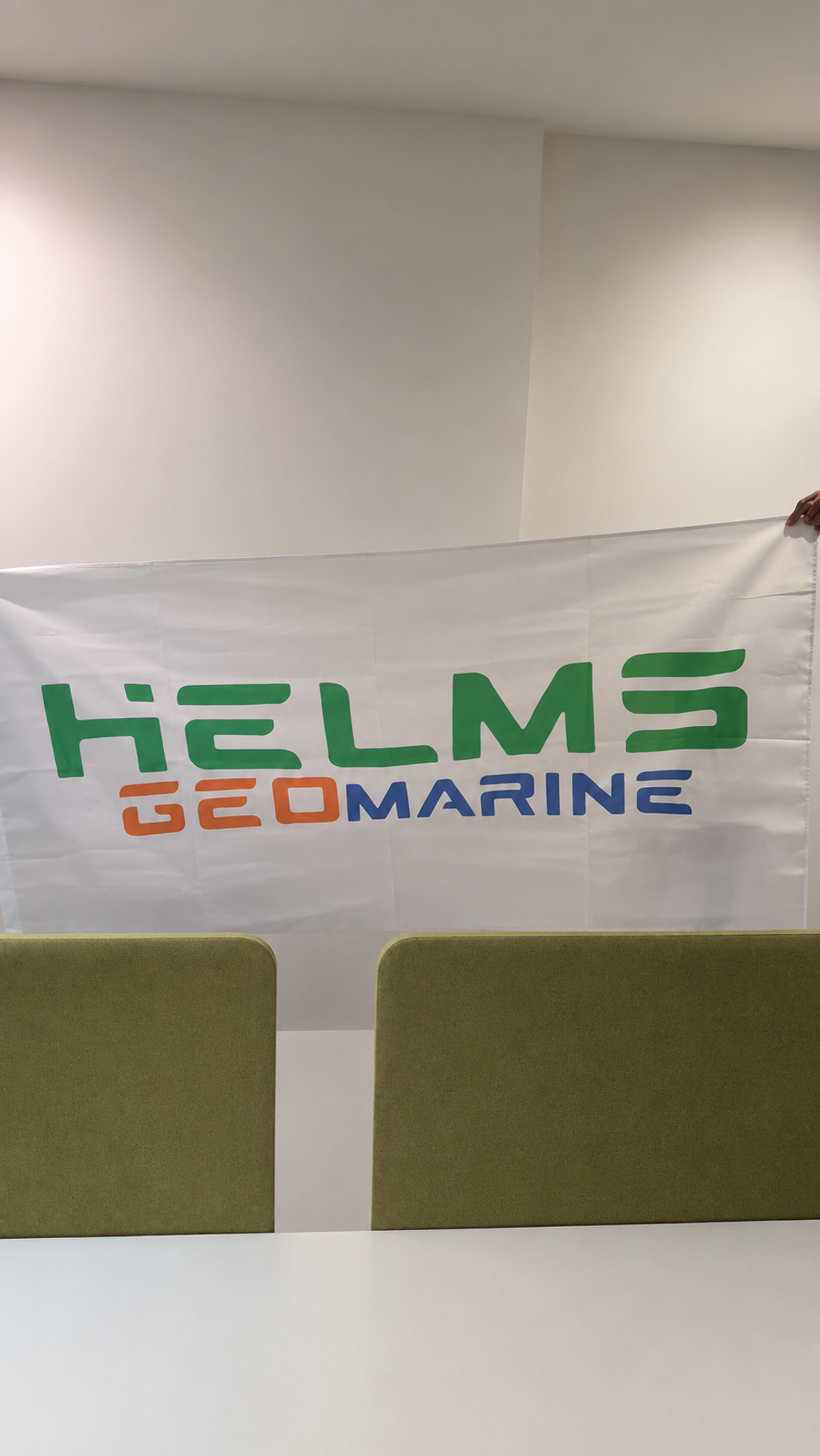 Company logo fabric flag held indoors for corporate branding