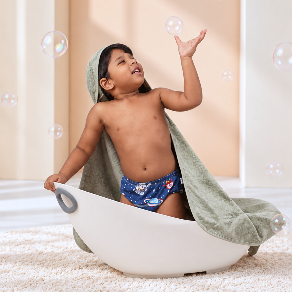 Child playing with bubbles in Sage Green towel
