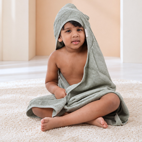 Toddler wrapped in Sage Green bamboo cotton terry hooded towel