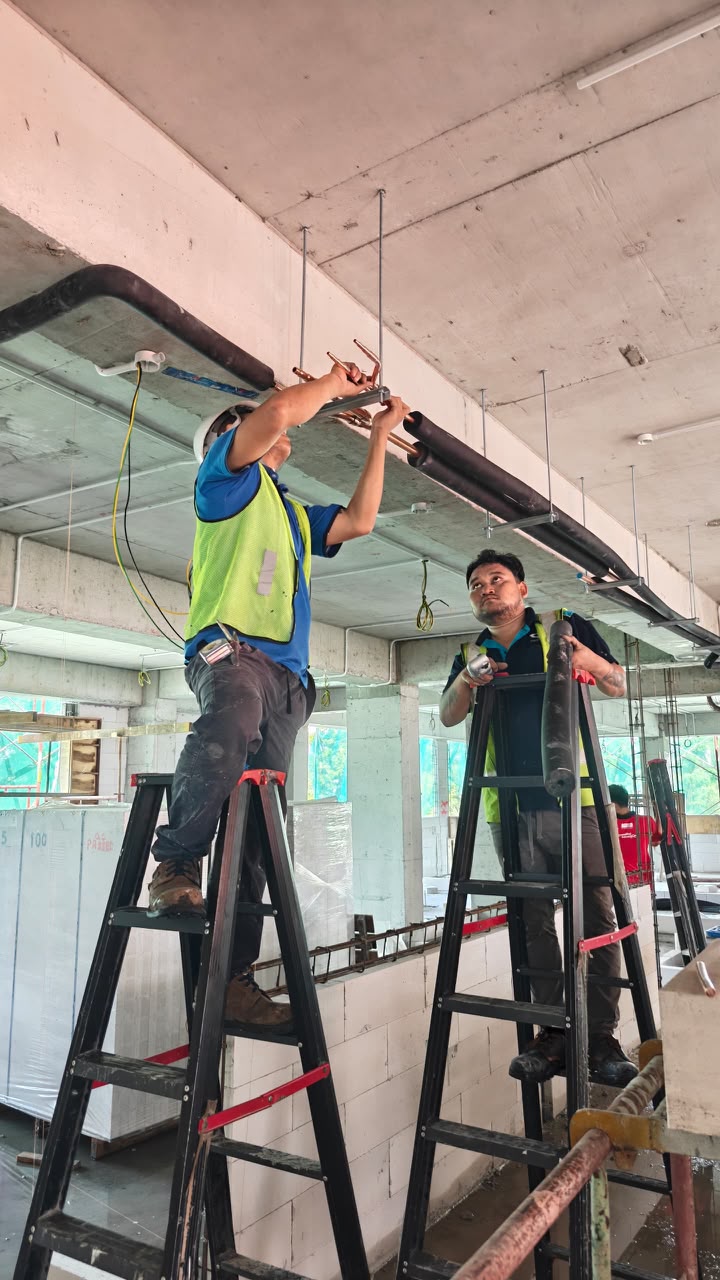 Technicians carrying out VRF pipework installation