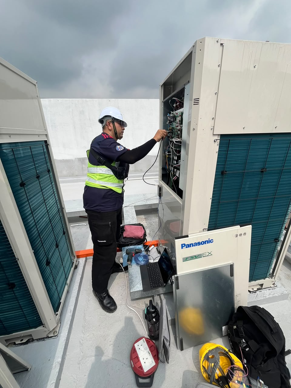 Thiam Seng technician working on a commercial VRF system
