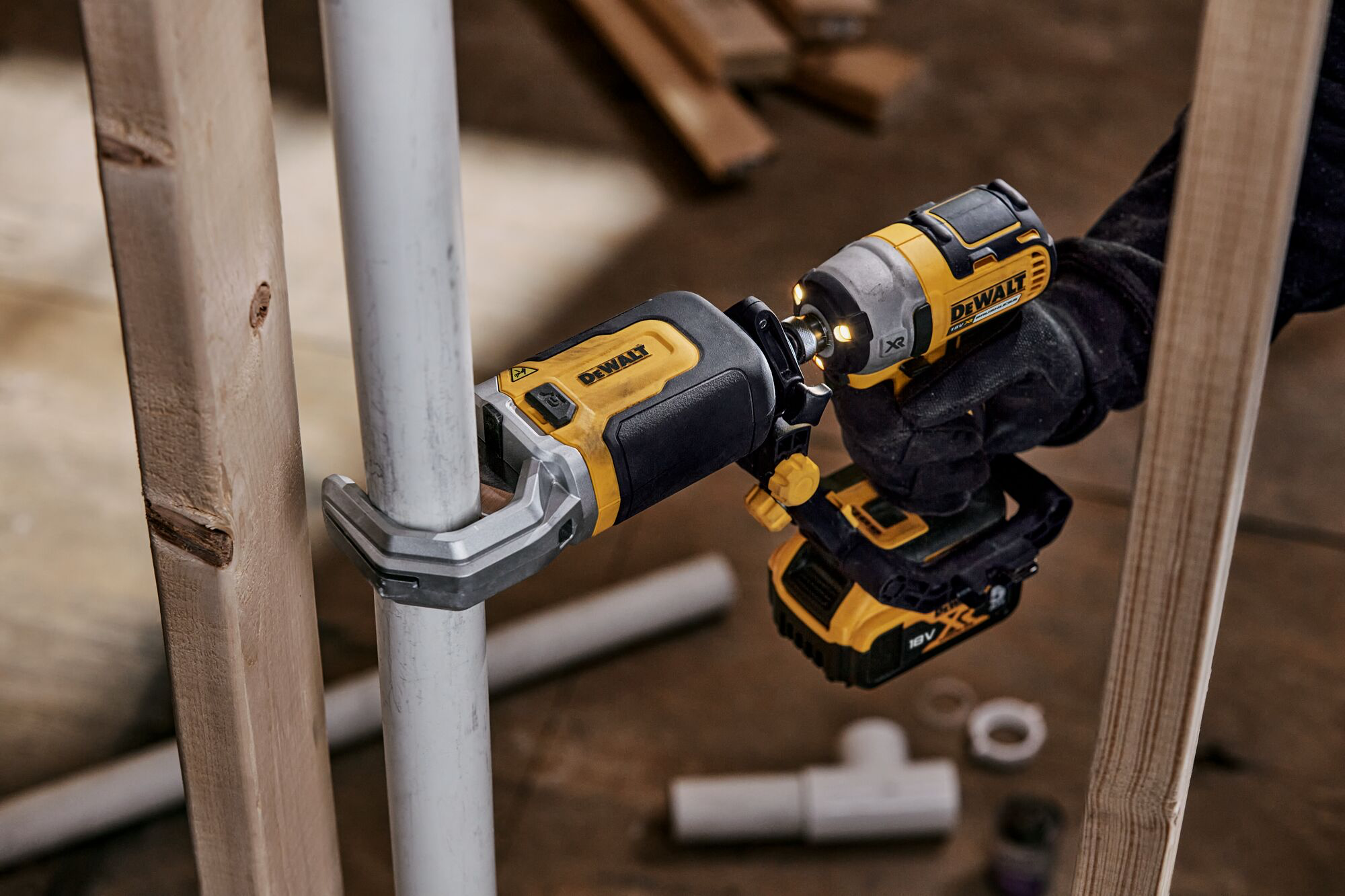 Impact Connect PVC/PEX pipe cutter attachment on Impact Driver cutting PVC pipe next to wood beam Impact Connect PVC/PEX pipe cutter attachment on Impact Driver cutting PVC pipe next to wood beam