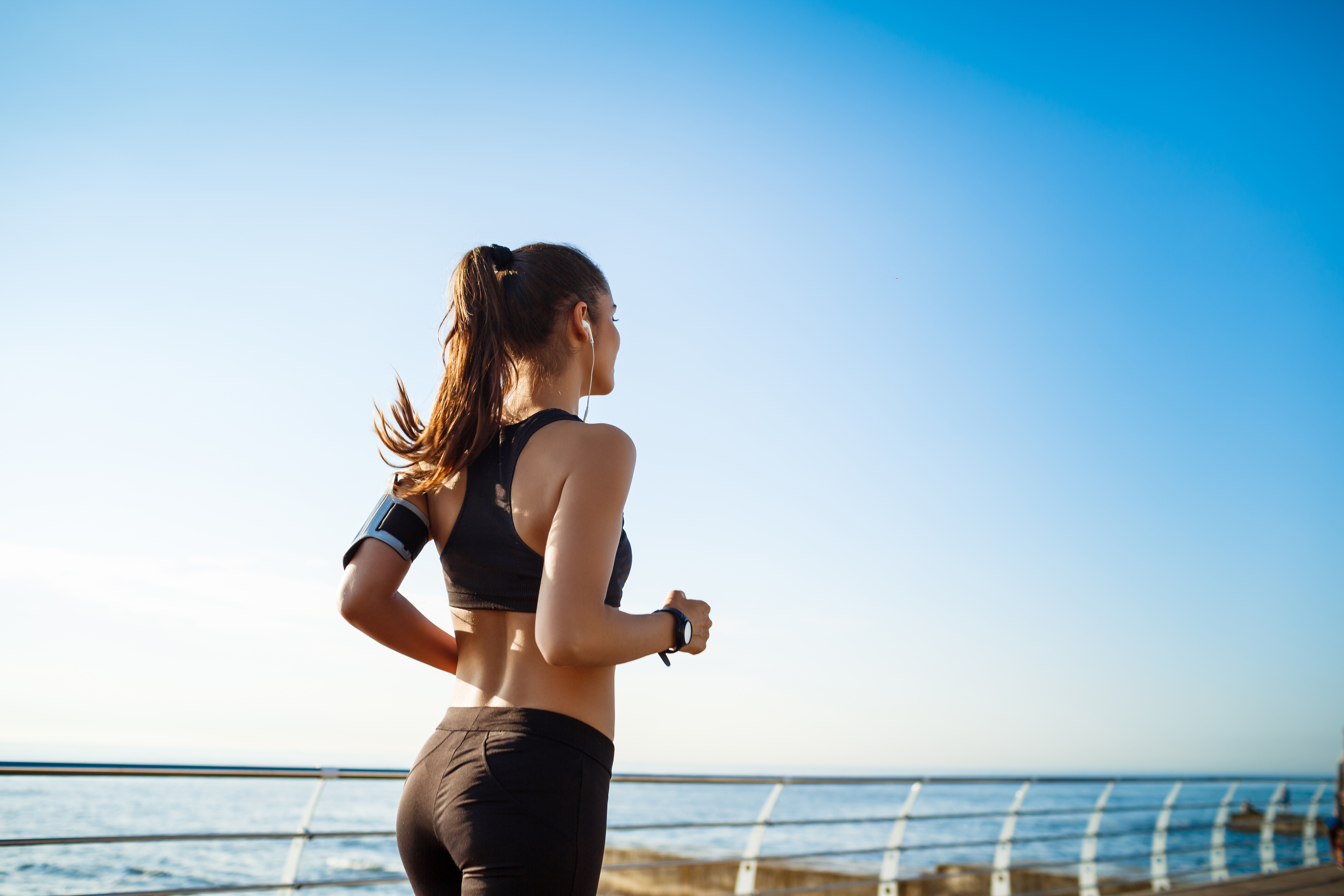 picture-young-attractive-fitness-woman-jogging-with-sea-wall