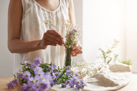 close-up-young-female-florist-making-tender-bouquet-workplace-copy-space