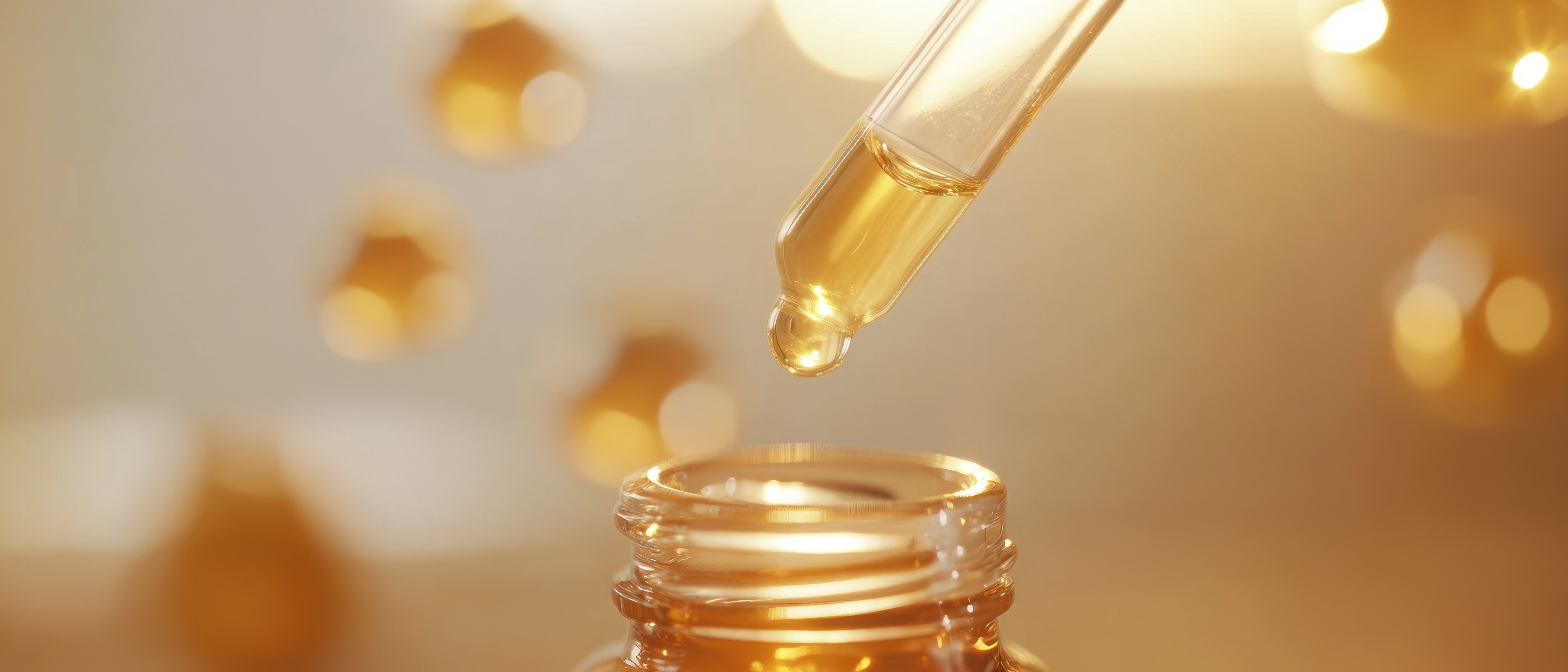 dropper-bottle-golden-liquid-with-bokeh-background