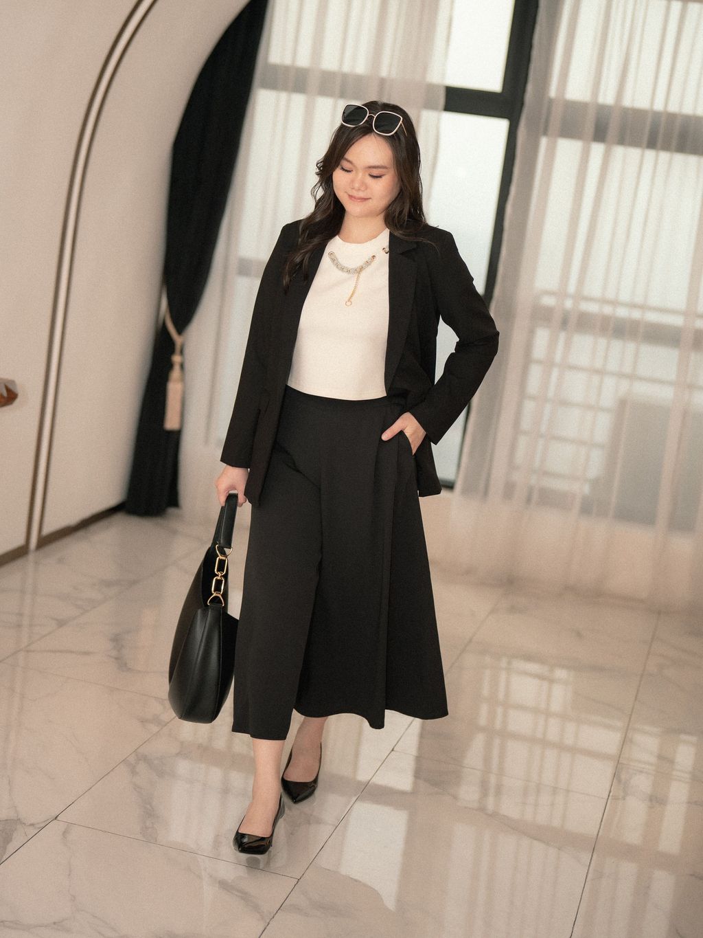 Sleek black blazer styled with wide-leg pants for a professional plus-size outfit