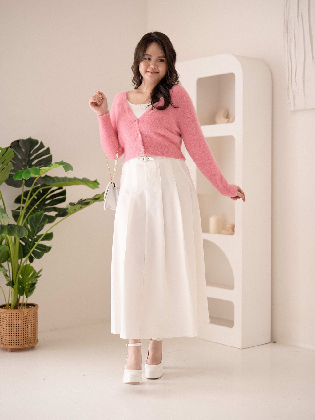 Plus-size model wearing Velvet Petal Cardigan in soft knit with petal-edge trim