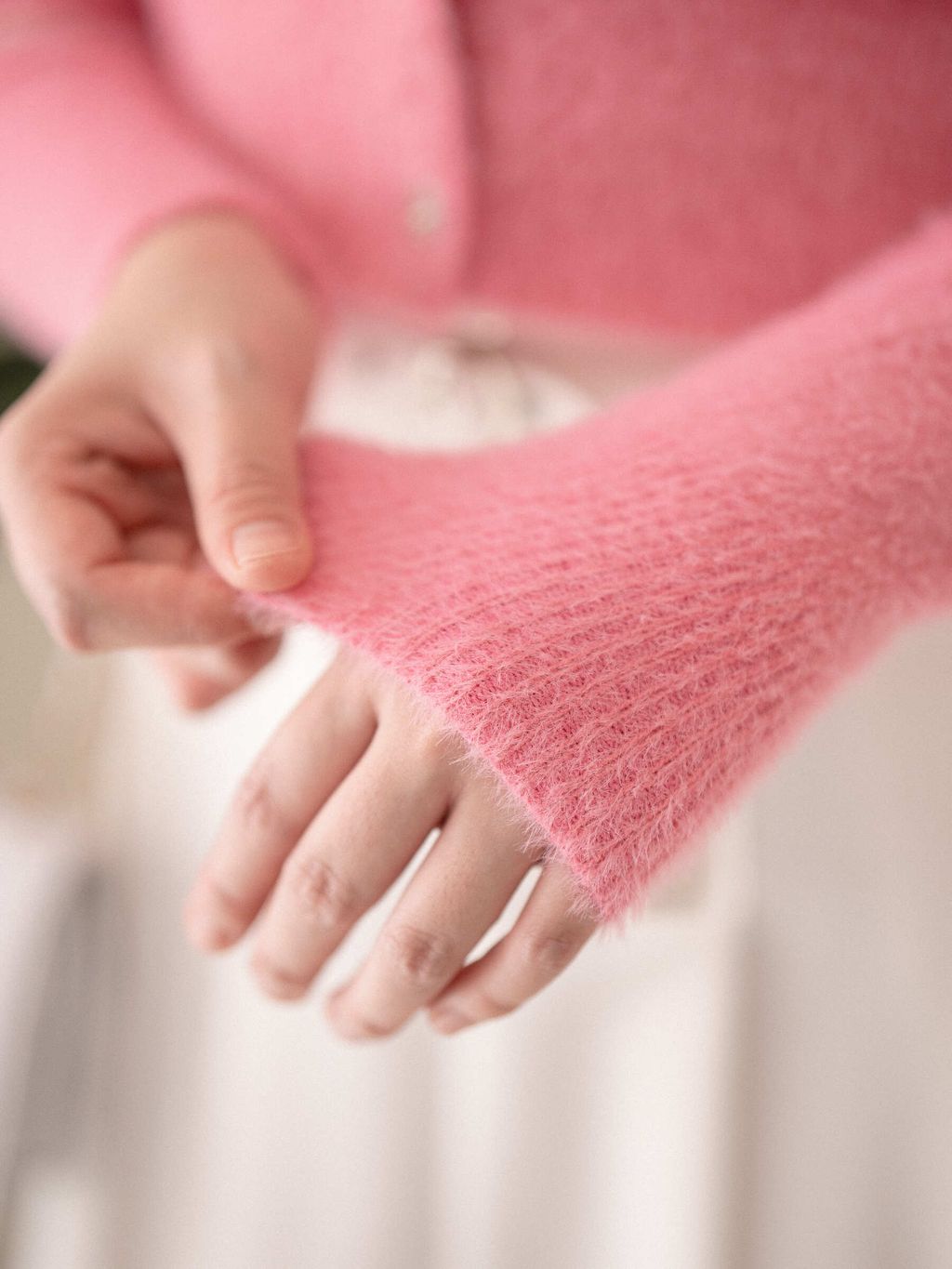 Close-up of soft knit fabric texture on Velvet Petal Cardigan, showing breathable weave