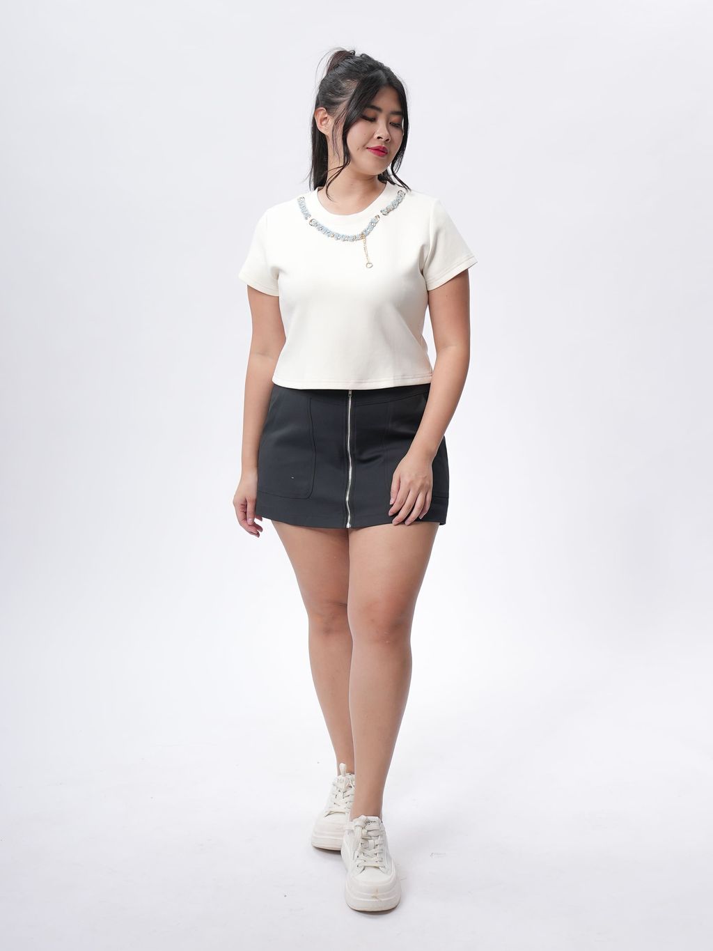 Curvy woman styling Tweed Petal Chain Top with denim skirt for a casual chic look