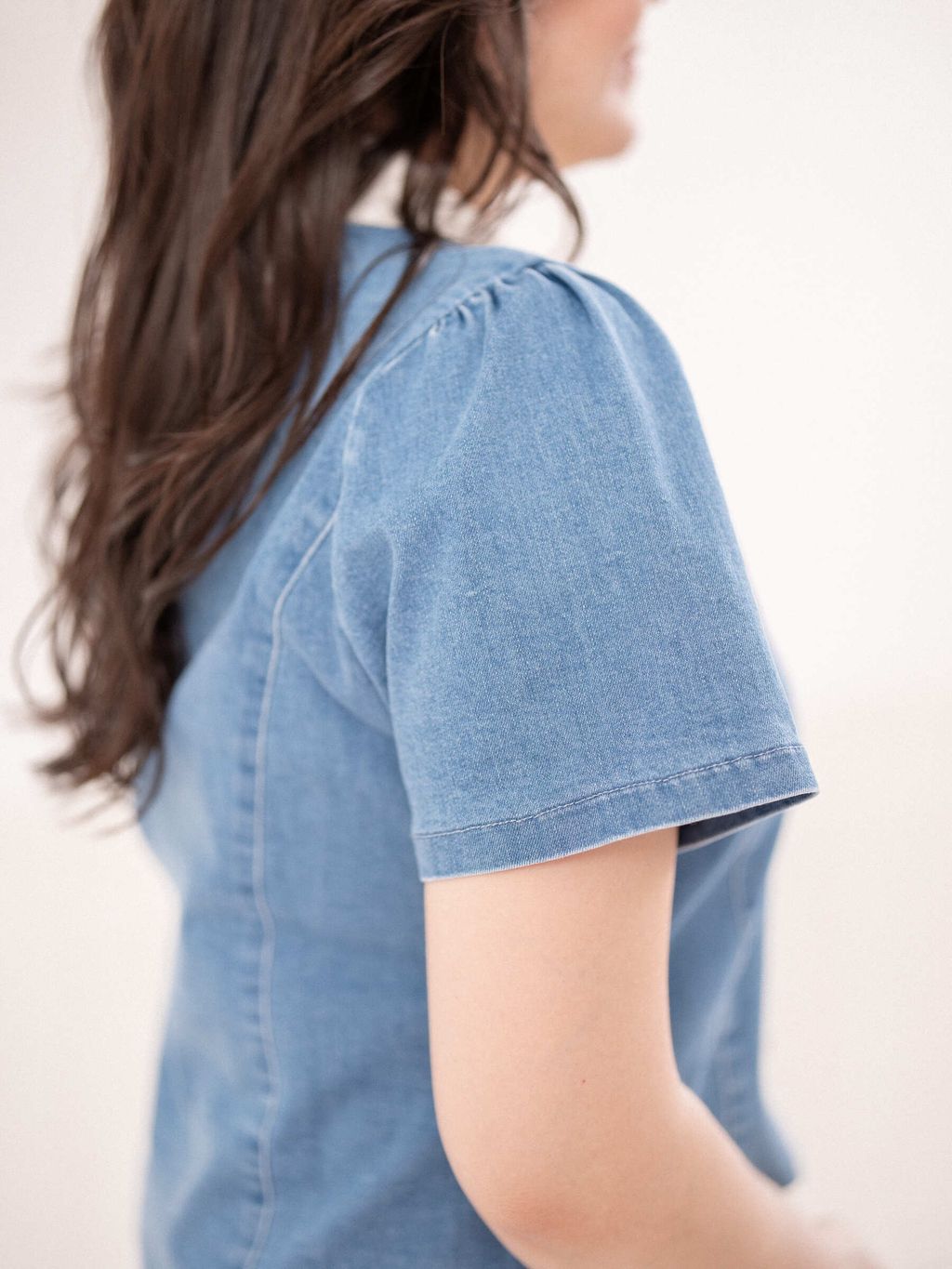 Back view of plus-size denim blouse with white inner collar