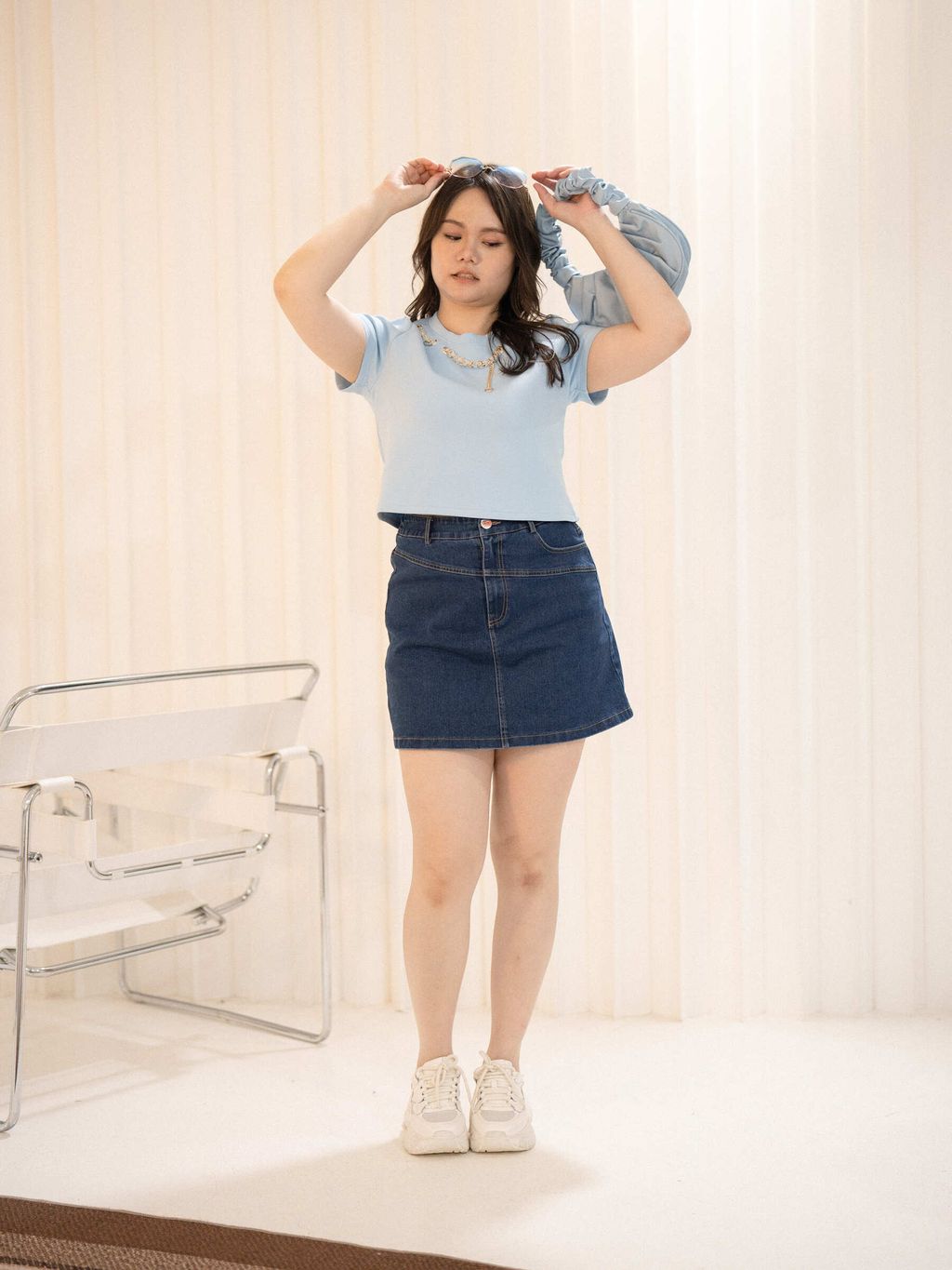 Plus-size casual outfit with denim skirt and sneakers