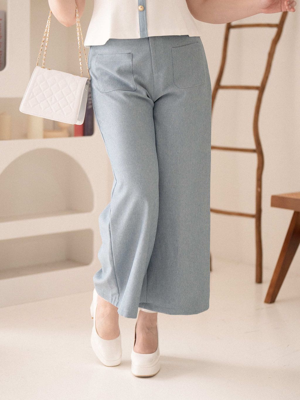 Plus-size outfit inspiration: structured pants paired with classic white heels.