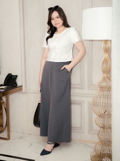 Plus-size woman wearing Grace Fit Wide Leg Pants in dark grey, styled with a white fitted blouse.
