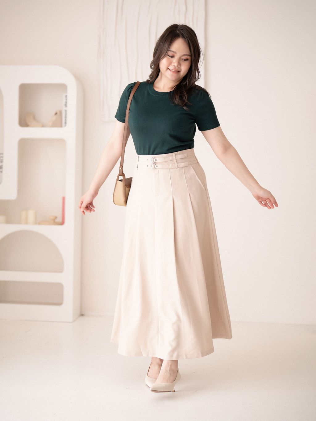 High-waisted beige midi skirt paired with forest green top – fresh and classy.