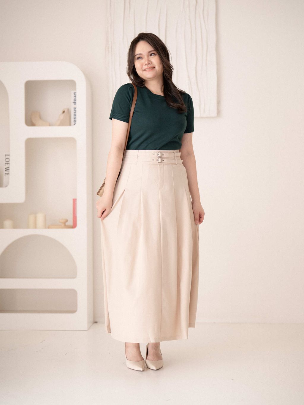 Beige pleated skirt in motion – flowing hem adds a soft, elegant silhouette.