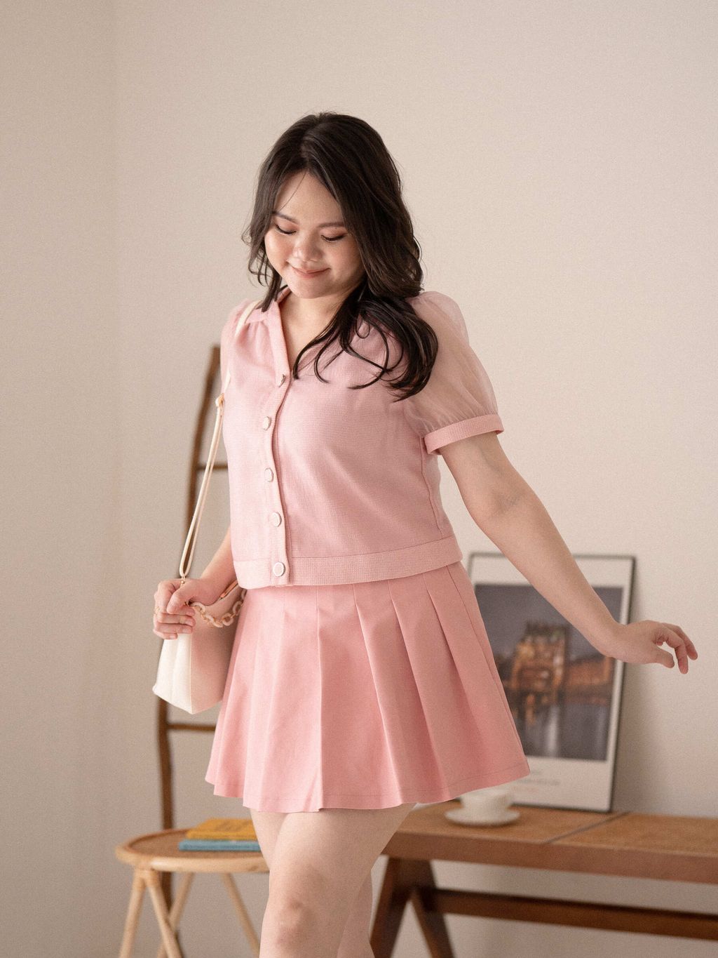 Plus-size skirt detail close-up showing crisp pleats and smooth fabric