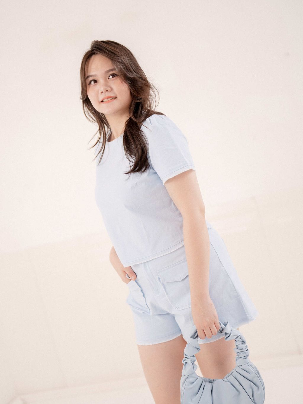 Baby blue shorts with flap pockets styled for summer