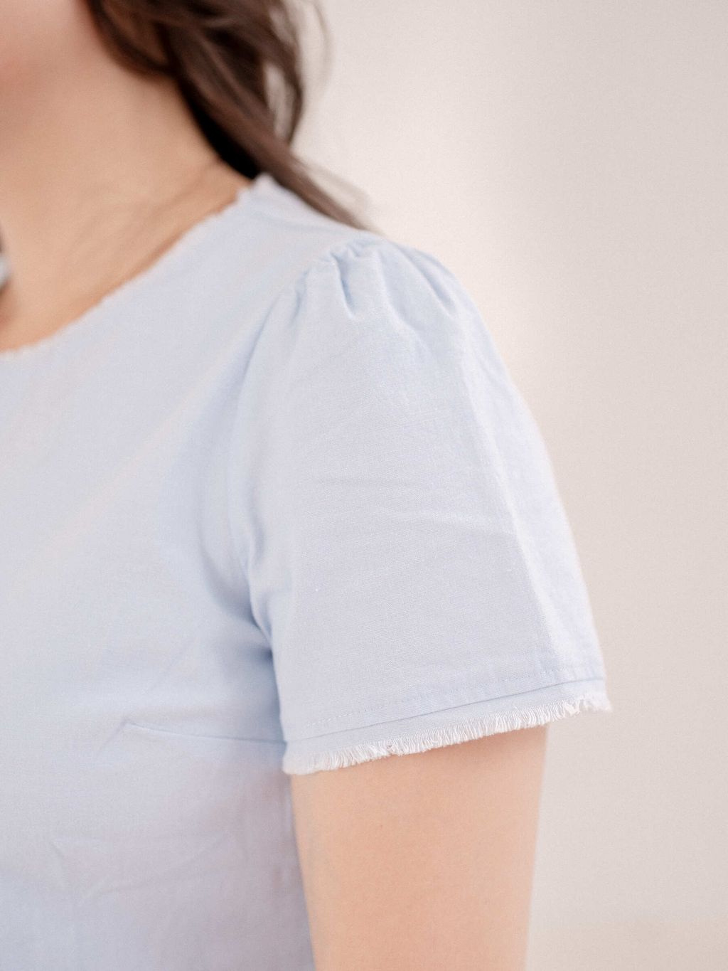 Close-up of frayed sleeve detail on matching top