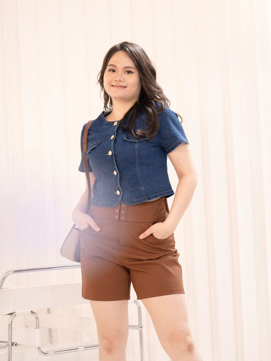 Front detail of cropped denim blouse with flap pockets