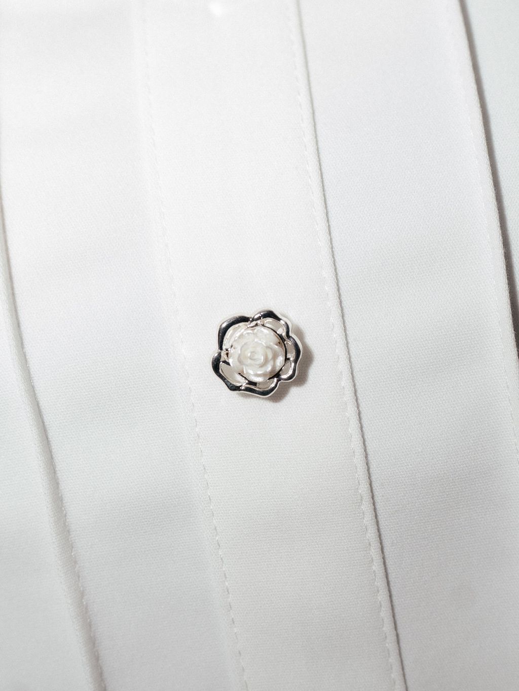 Close-up of floral button on blouse