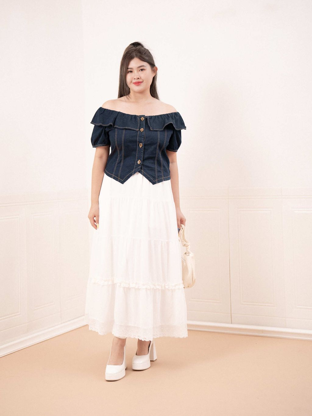 Dark blue denim top with contour seams that shape and flatter the waistline.