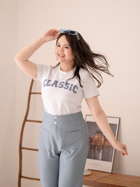 Plus size grey Classic tee with fluffy textured lettering, styled with light blue pants.