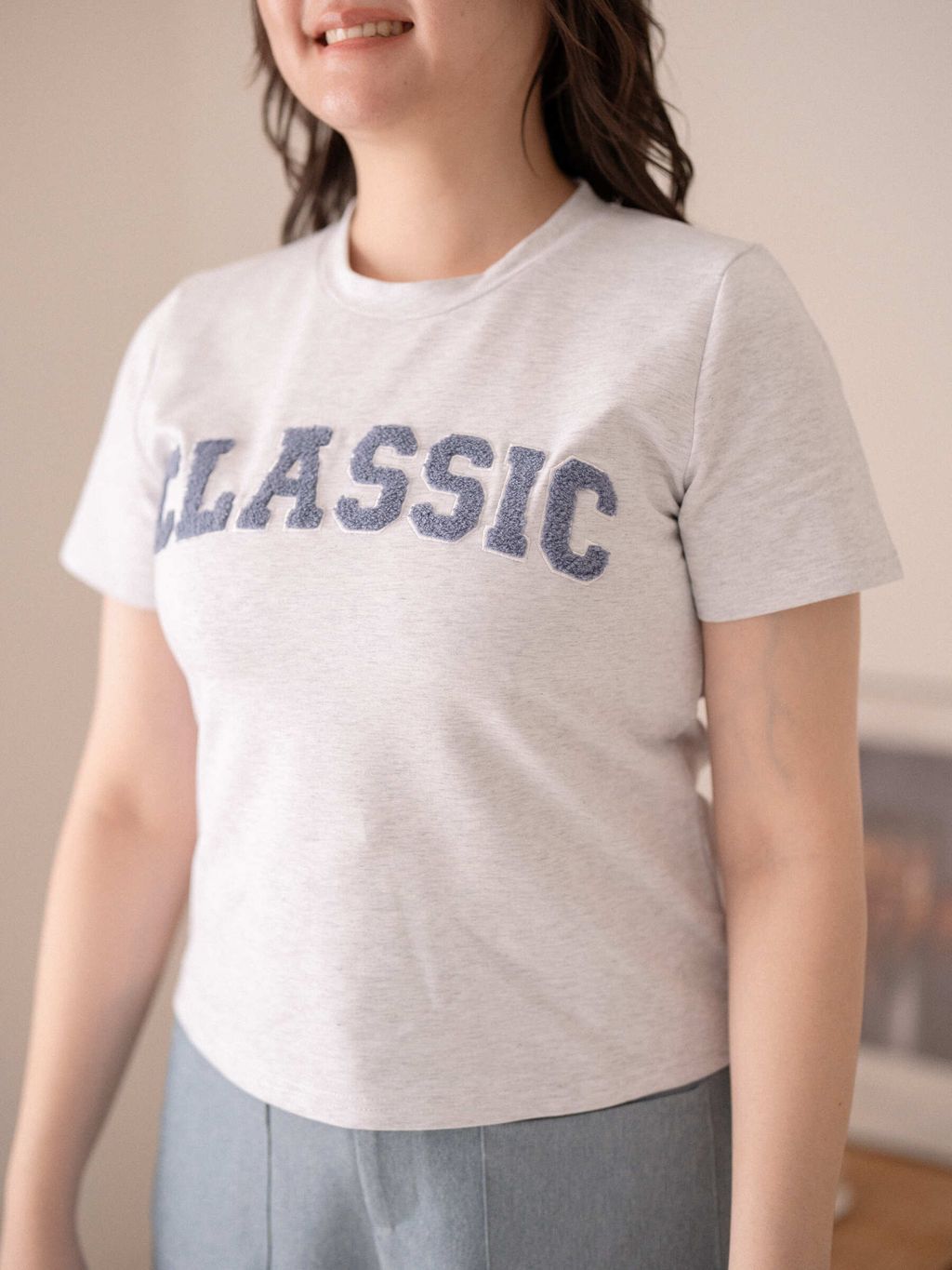 Close-up of fluffy chenille “CLASSIC” letters on soft cotton tee.