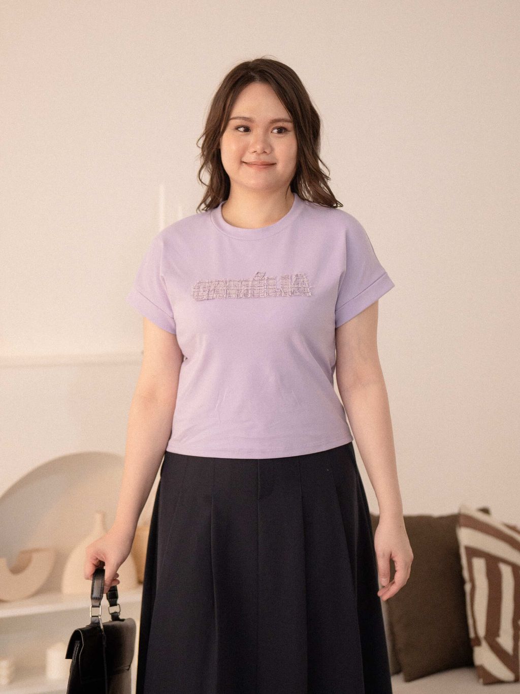 Casual plus-size look with the Signature Patch Tee in light purple, paired with black tailored shorts for a youthful and confident vibe.