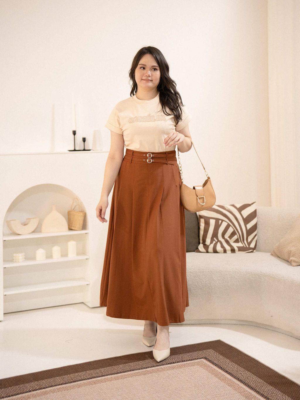 Signature Patch Tee in light beige, styled with a high-waisted rust-colored maxi skirt, creating an elegant and relaxed plus-size outfit.