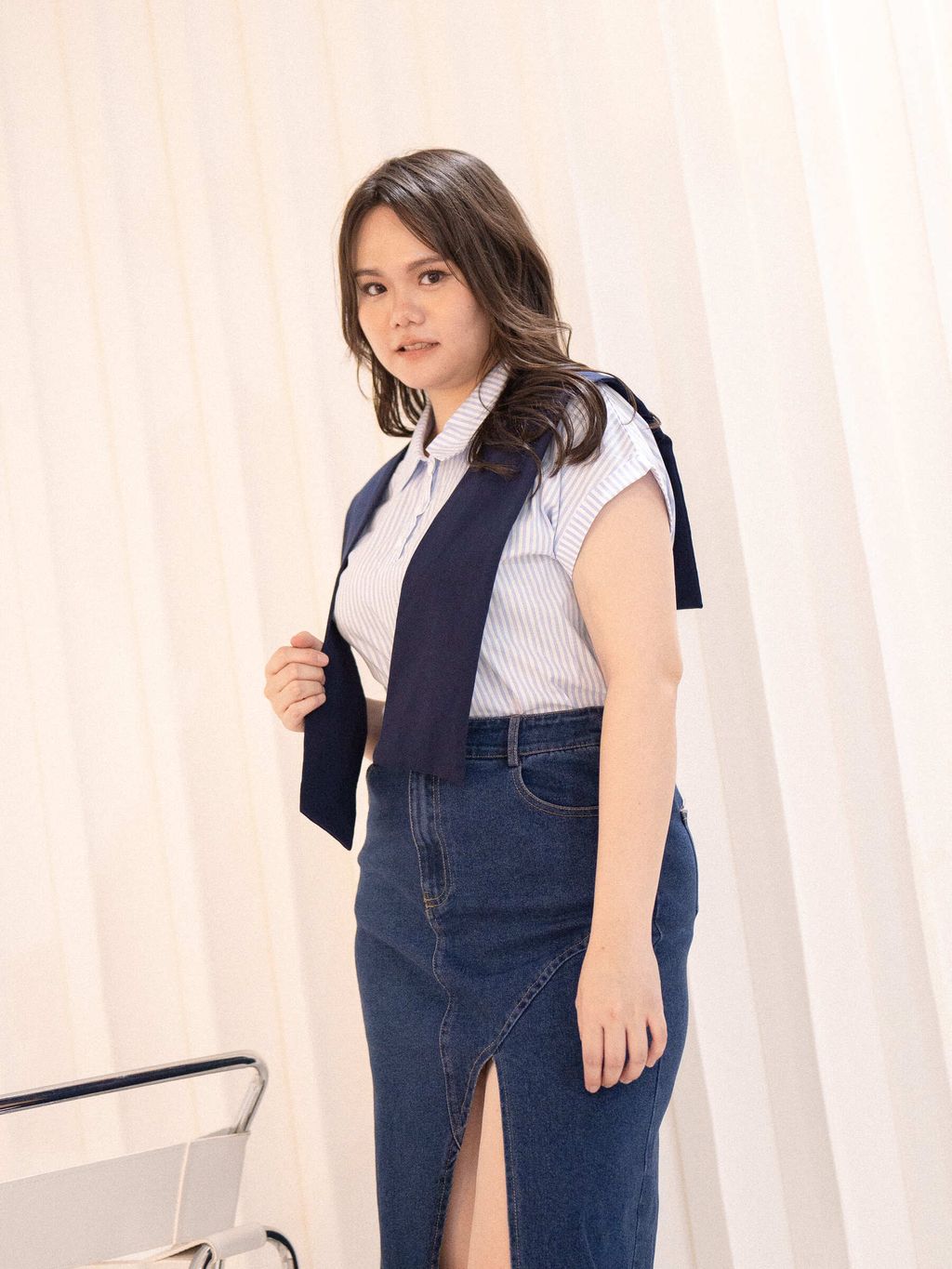 Side pose showing flattering fit of striped short-sleeve polo top