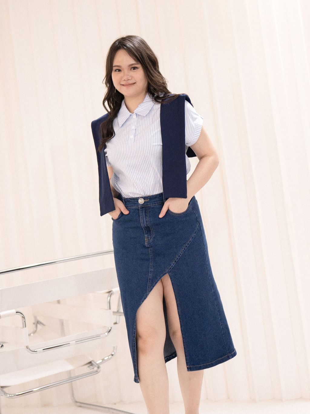 Polo collar striped top styled with shoulder sweater and denim skirt