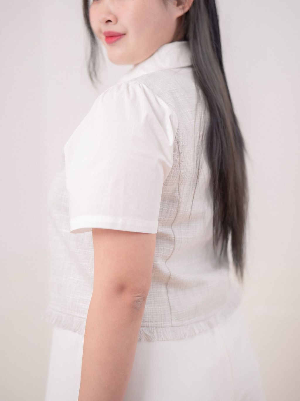 Frayed hemline detail enhancing fabric contrast.