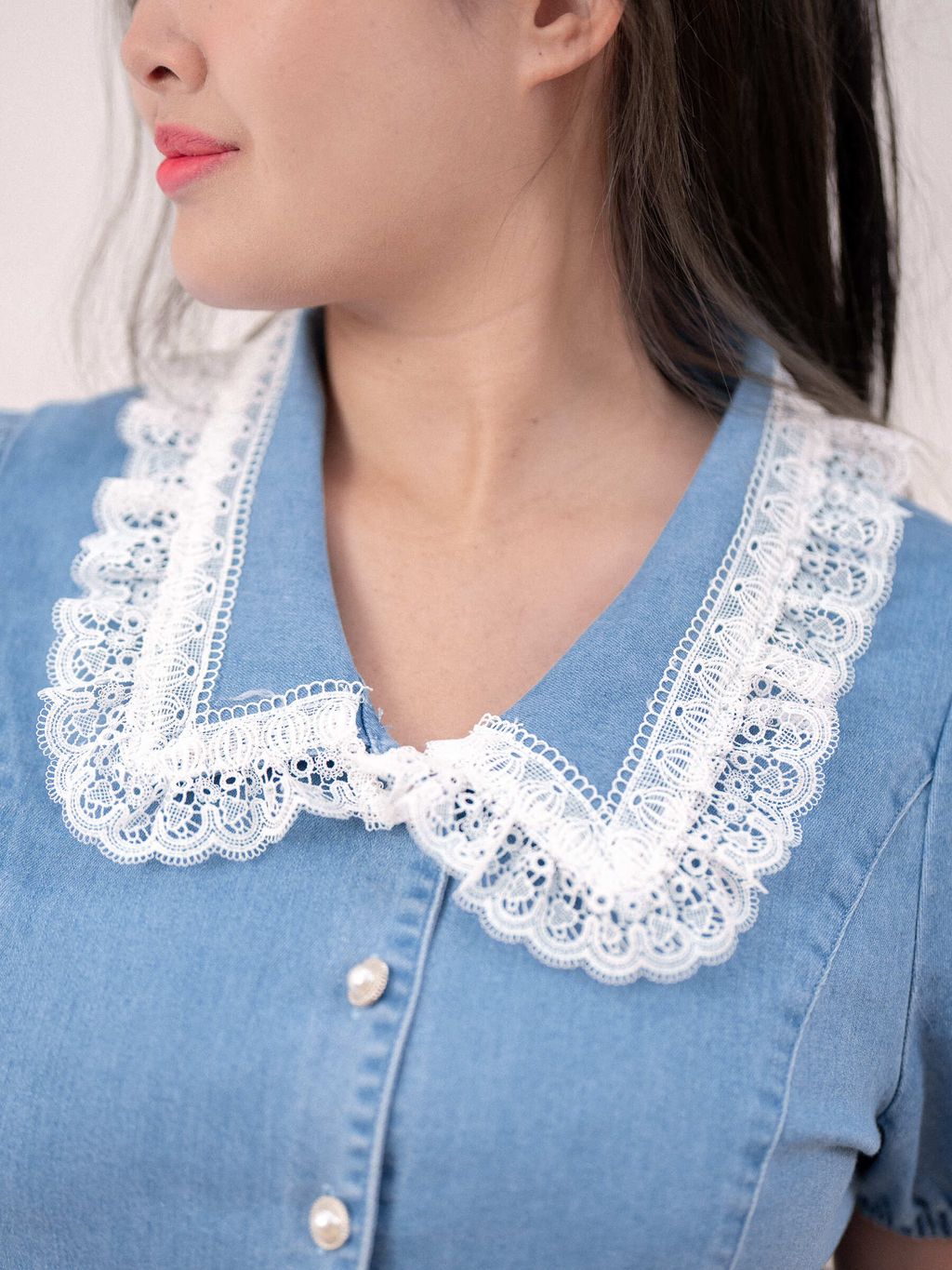 Pearl buttons accenting the front of the denim top