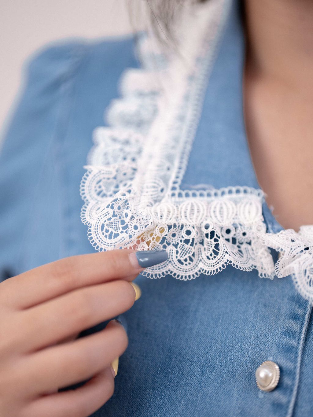 Close-up of delicate white lace trim on collar