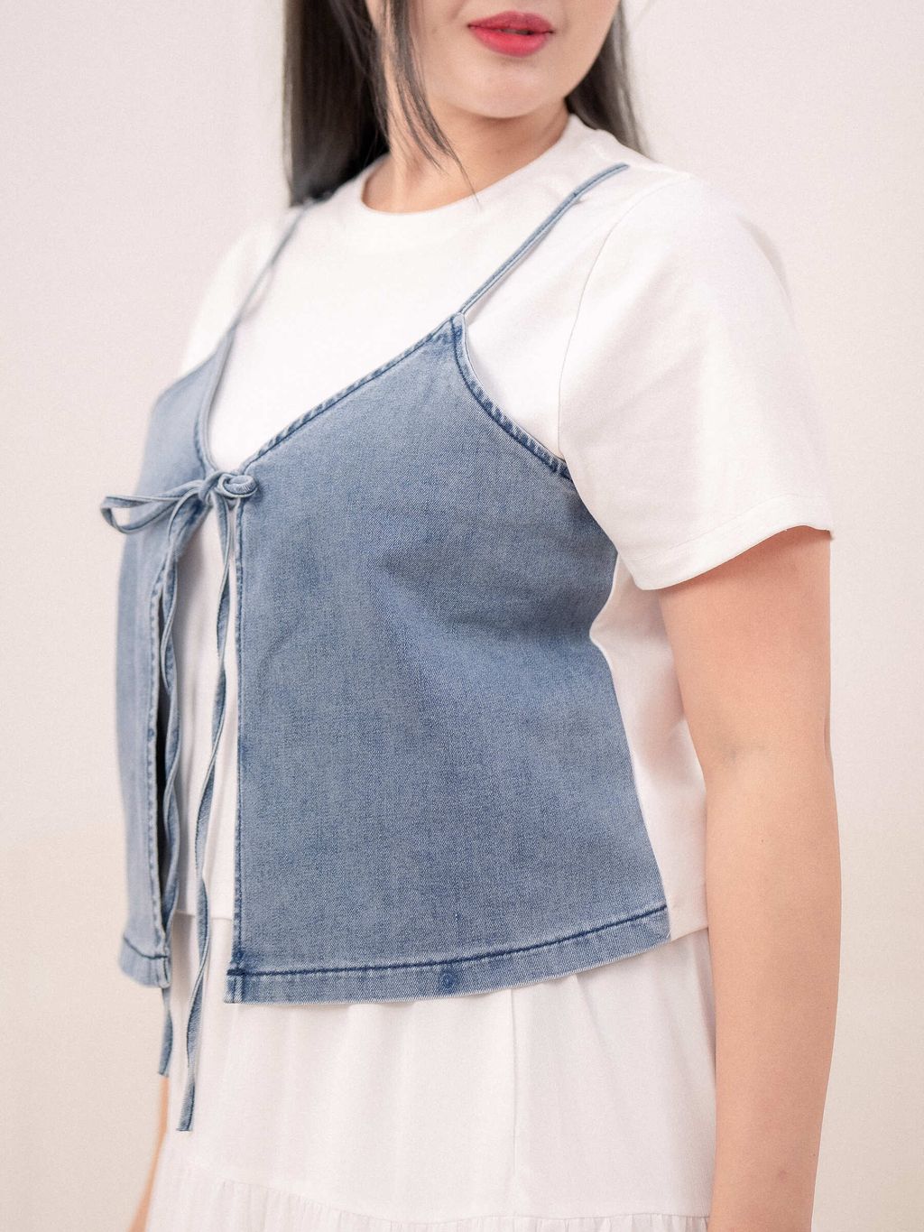 Close-up of denim texture and tie-front knot