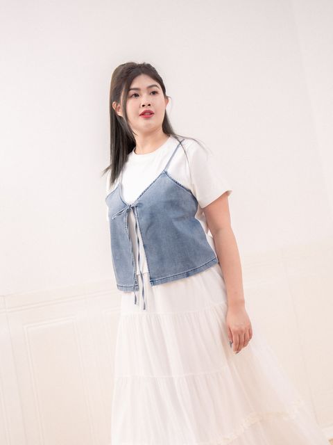 Front view of denim vest with tie detail and soft washed texture