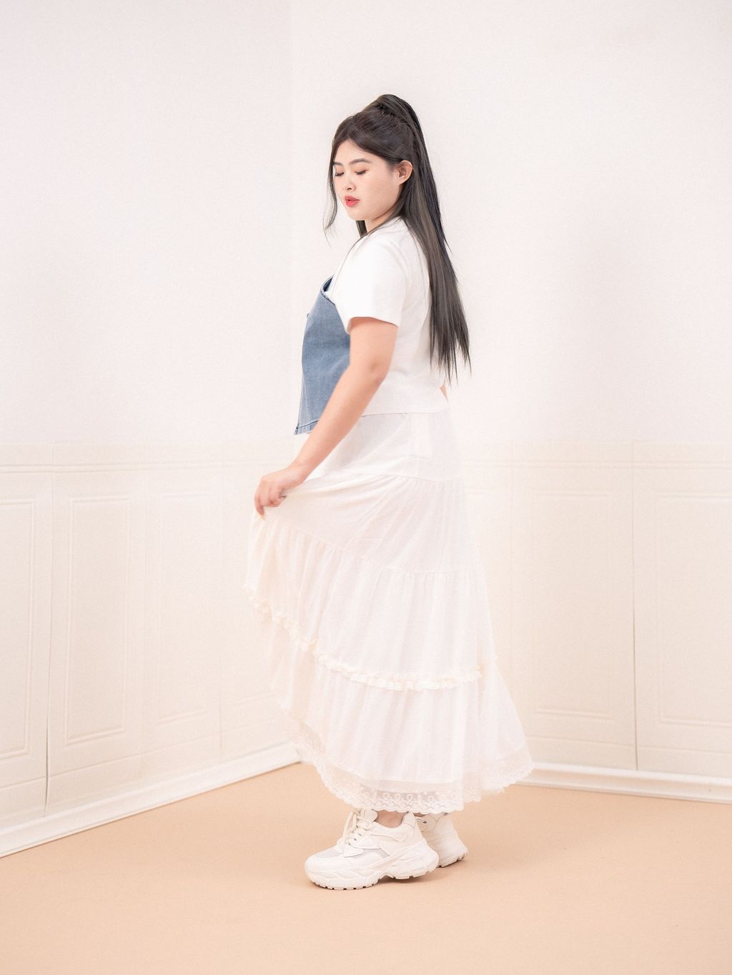 Back side view showing cropped length and shoulder strap design