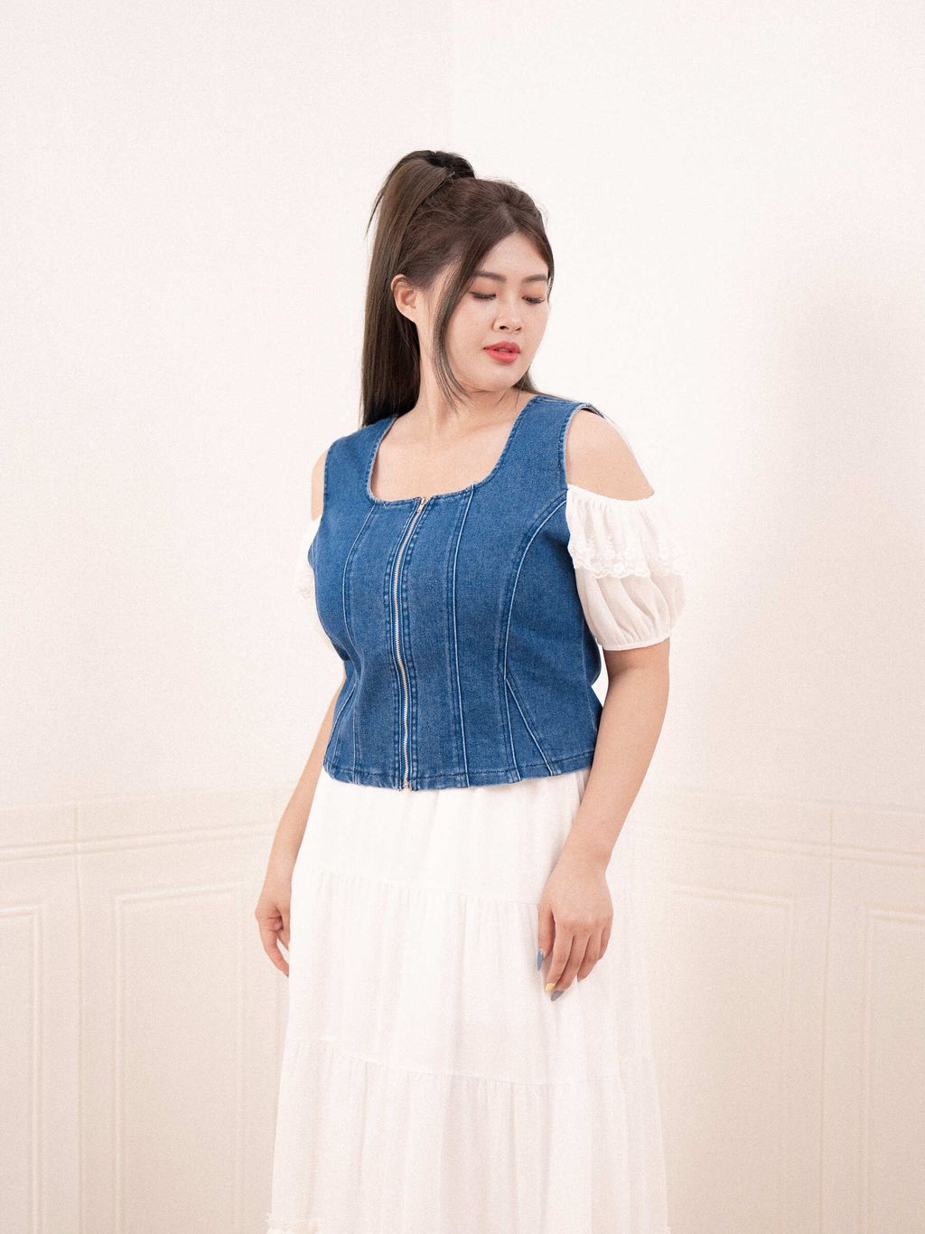 Side profile of denim top showing structured silhouette
