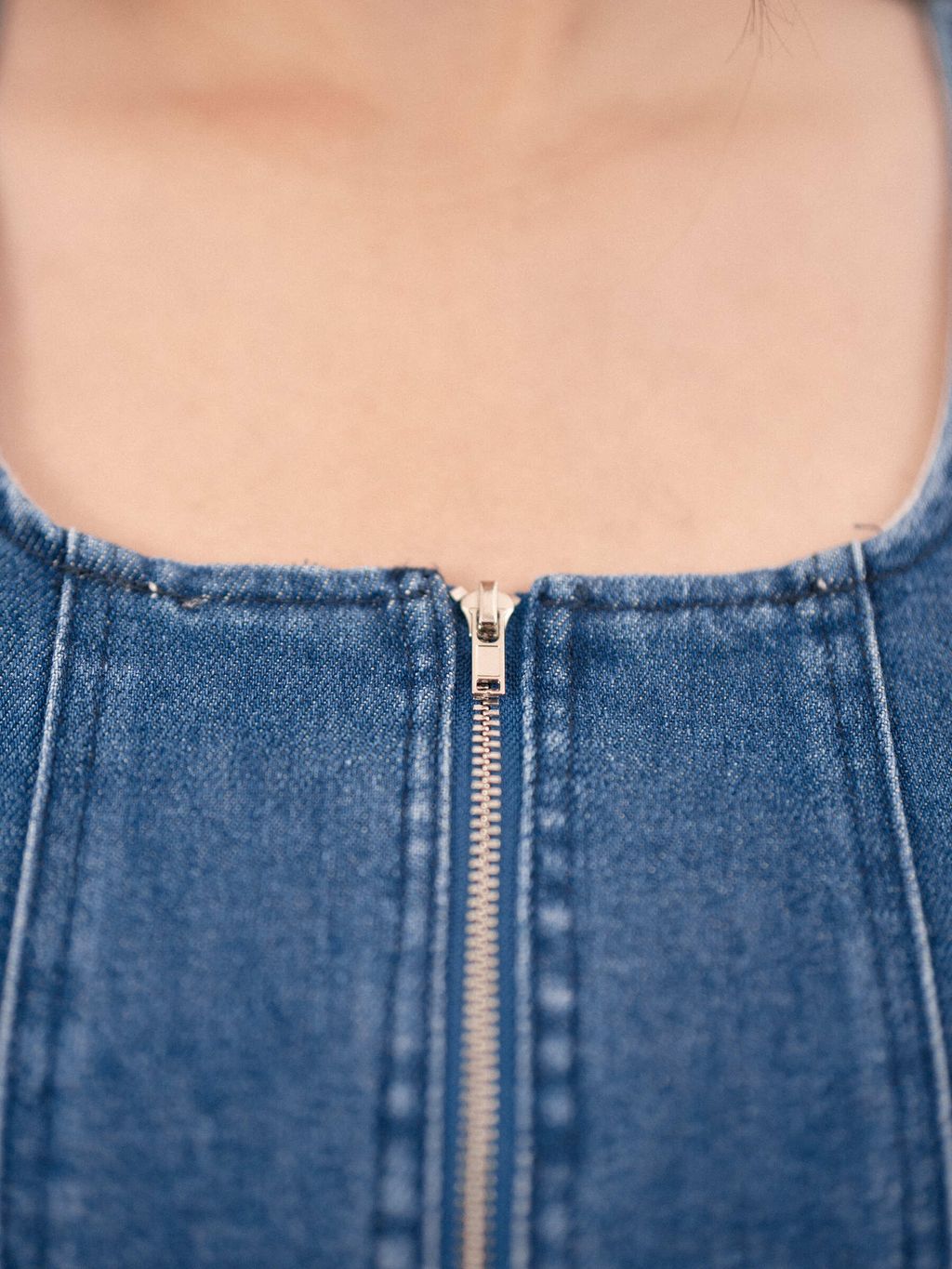 Close-up of denim top zipper with visible seam details