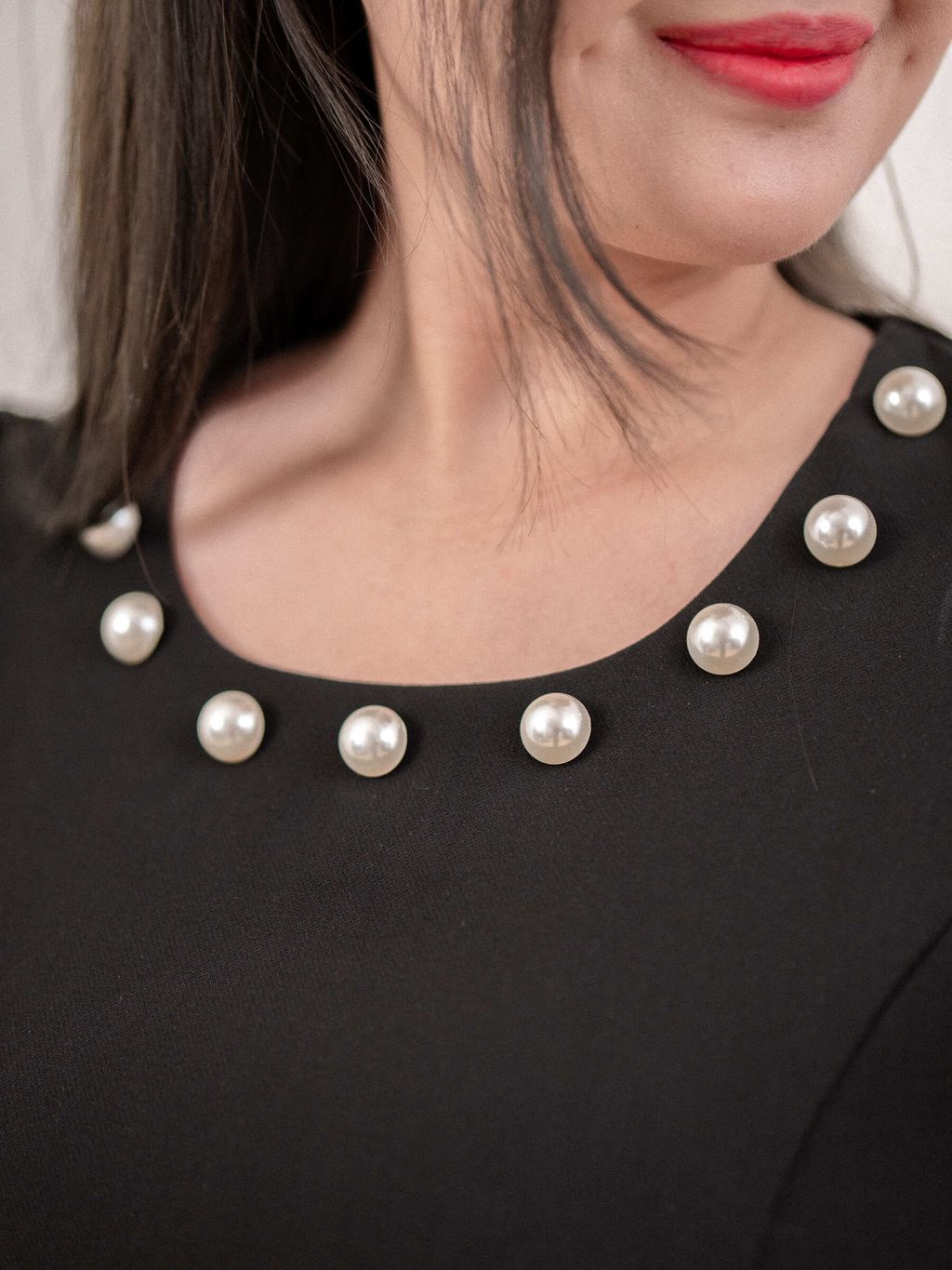Close-up of pearl details on neckline