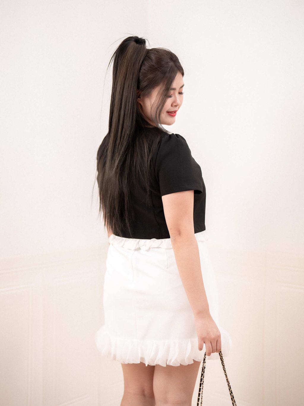 Back view of ruffle-trim skirt with pocket detail