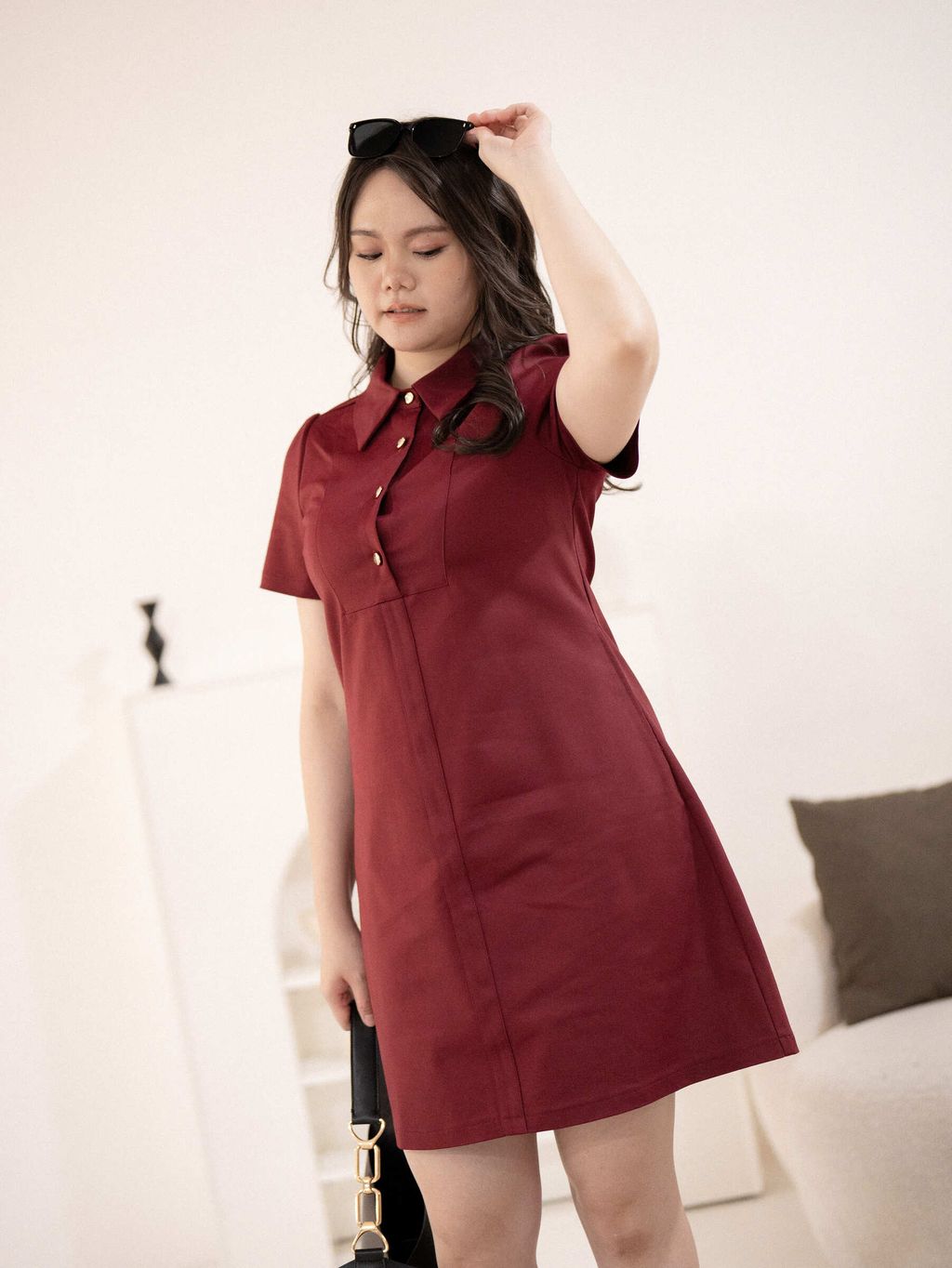 Detailed shot of collar and textured gold button on red dress