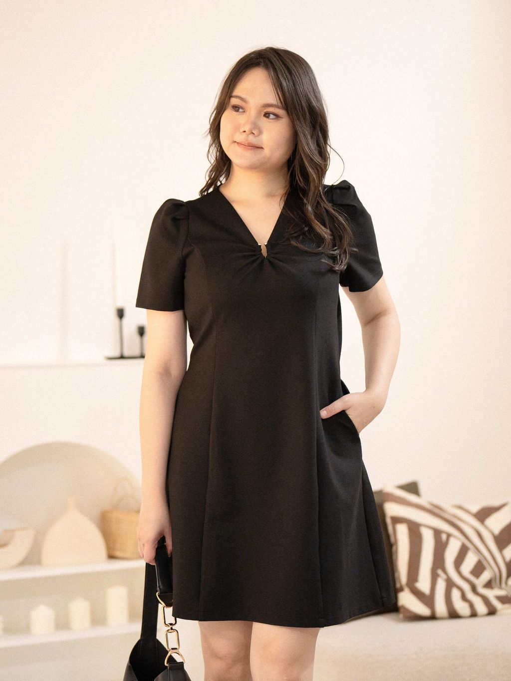 Confident pose showcasing full silhouette of the elegant plus-size black dress