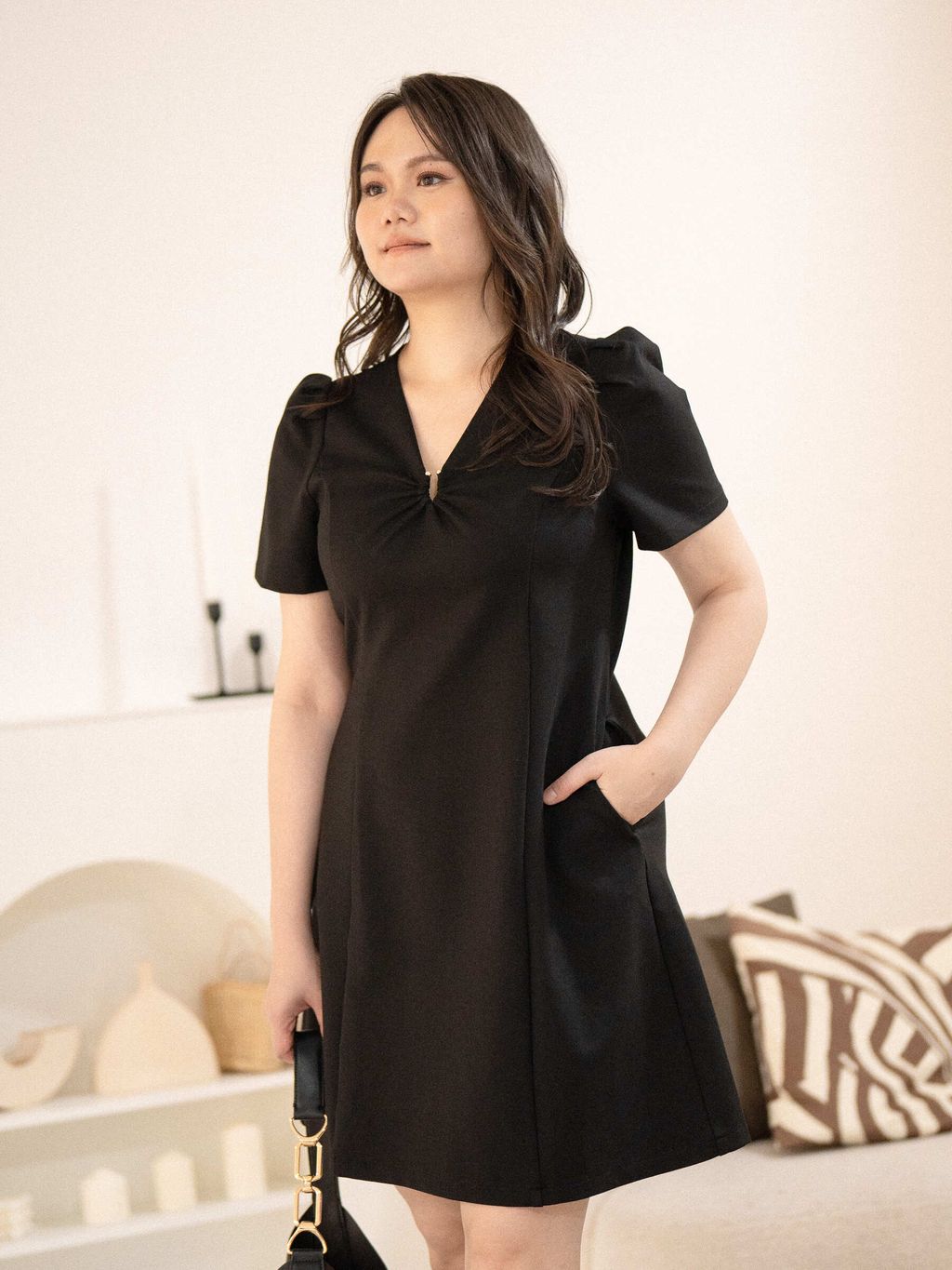 Side view of plus-size model with hand in hidden pocket, showcasing the dress’s clean A-line cut.